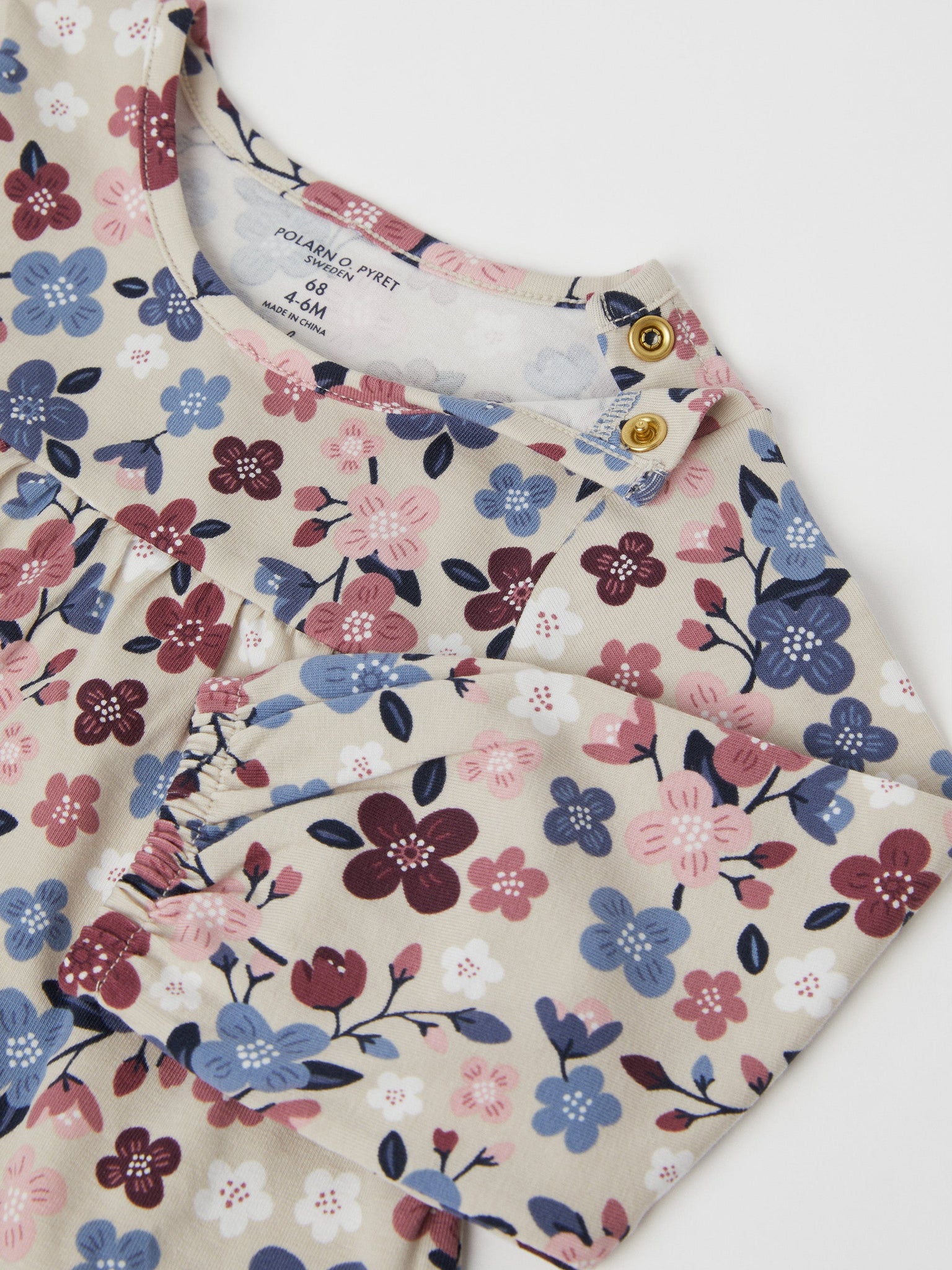Organic Cotton Floral Baby Dress from the Polarn O. Pyret baby collection. Nordic baby clothes made from sustainable sources.