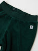 Green Velour Baby Trousers from the Polarn O. Pyret baby collection. Nordic baby clothes made from sustainable sources.