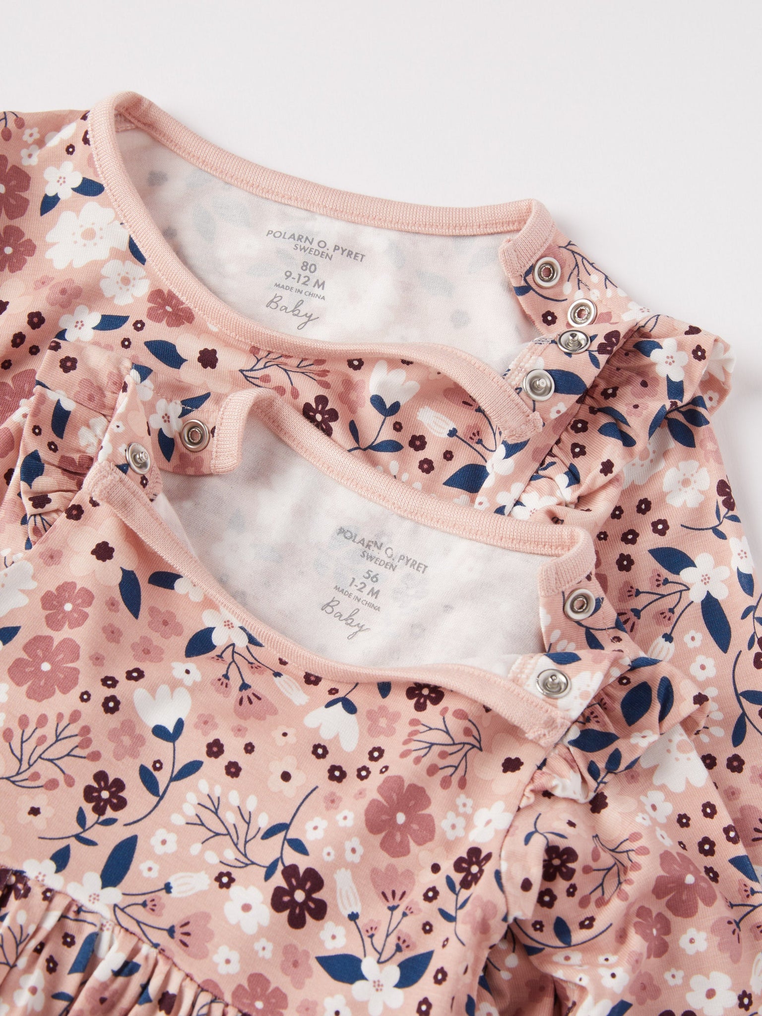 Floral Print Baby Bodysuit Dress from the Polarn O. Pyret baby collection. Clothes made using sustainably sourced materials.