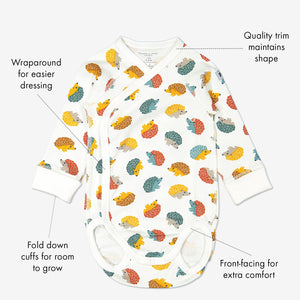 GOTS organic cotton long sleeve babygrow in a unisex hedghog print with text labels shown on the sides