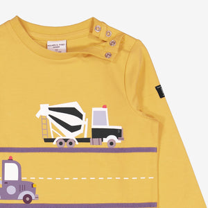  Yellow Truck Print Baby Top from Polarn O. Pyret Kidswear. Made using sustainable materials.
