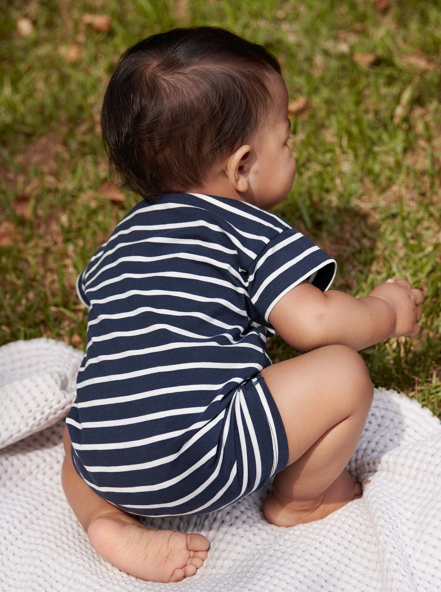 Striped Navy Newborn Baby Romper from Polarn O. Pyret Kidswear. Made using sustainable sourced materials.