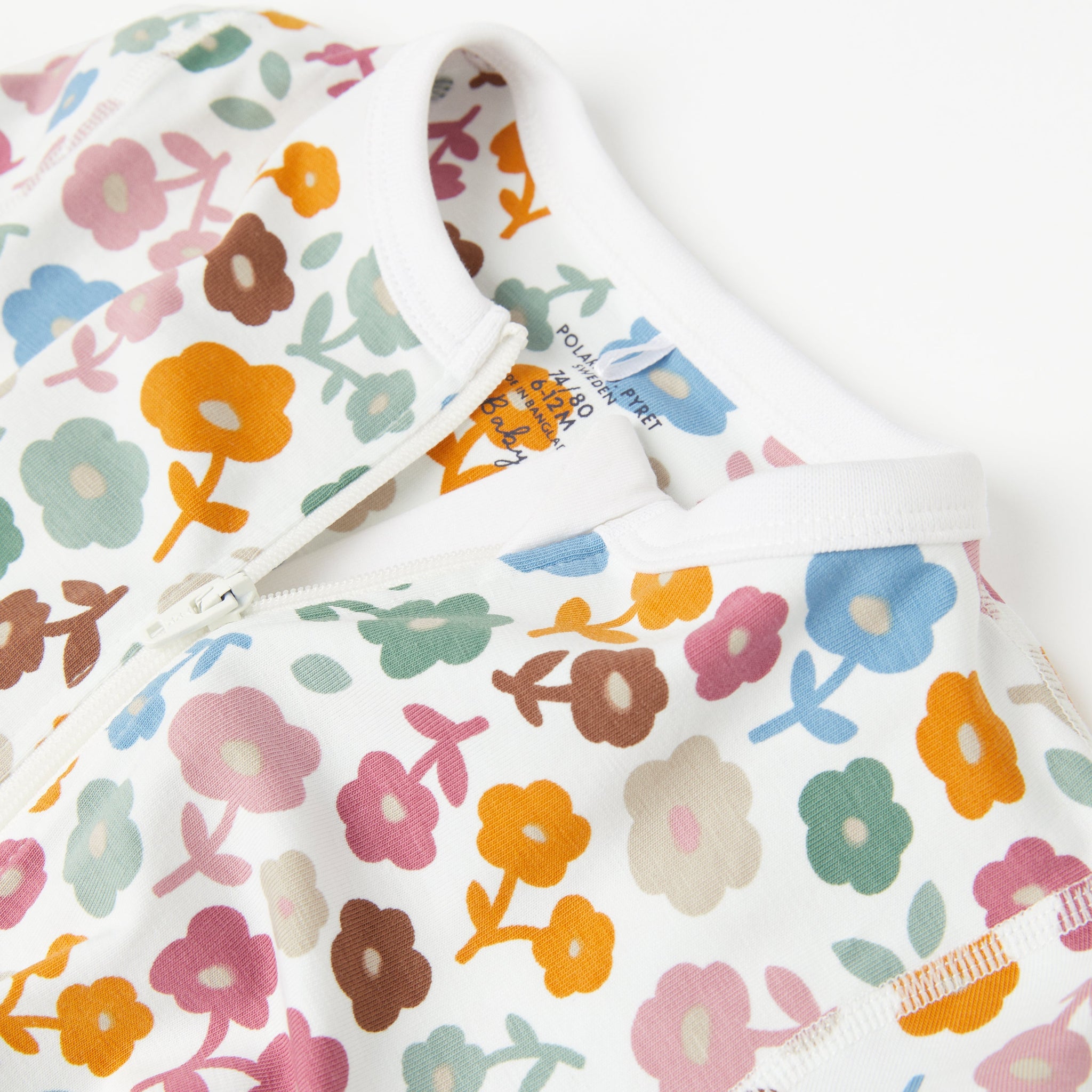 Floral Print White Baby Sleepsuit from the Polarn O. Pyret Kidswear collection. Clothes made using sustainably sourced materials.