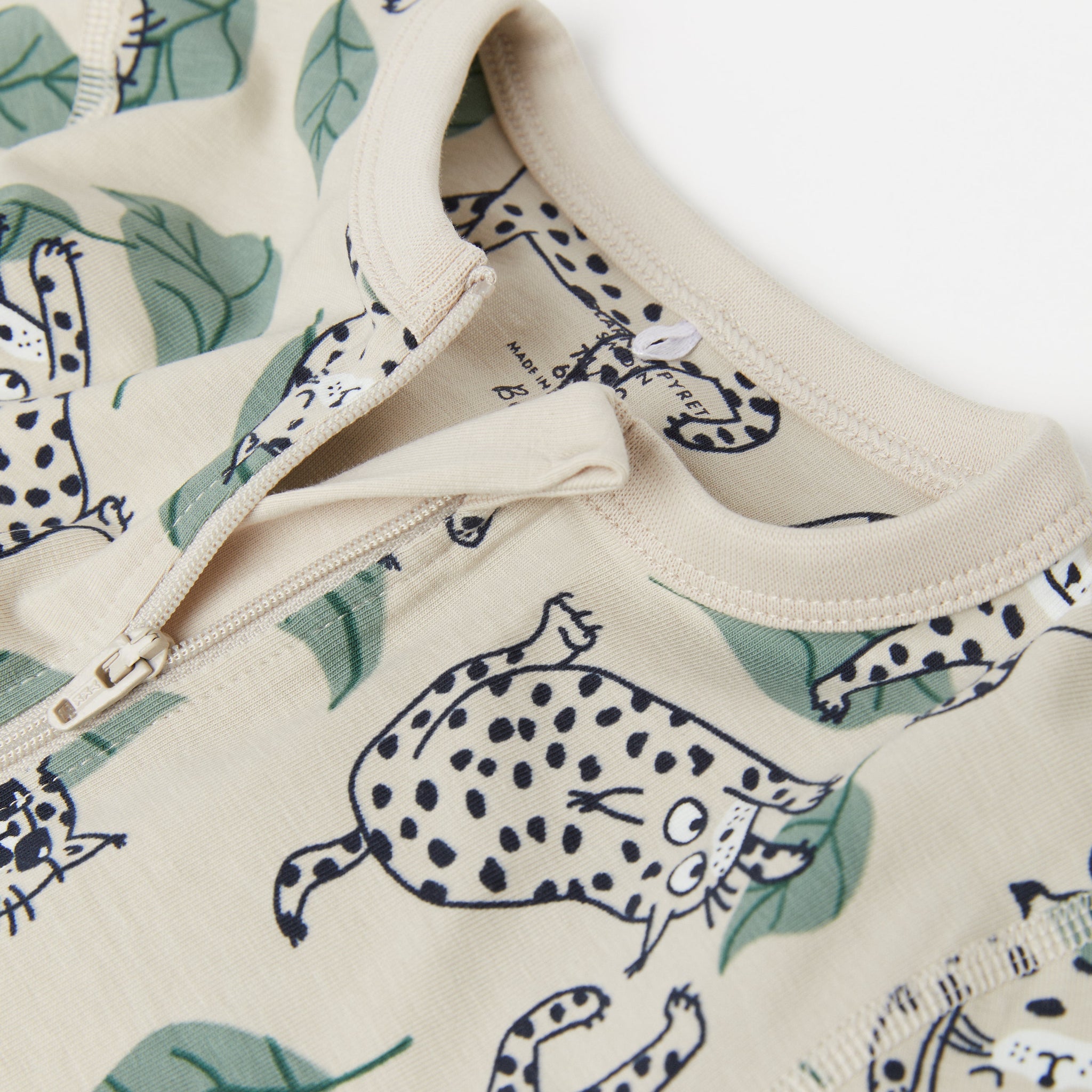 Big Cat Beige Baby Sleepsuit from the Polarn O. Pyret Kidswear collection. The best ethical kids clothes