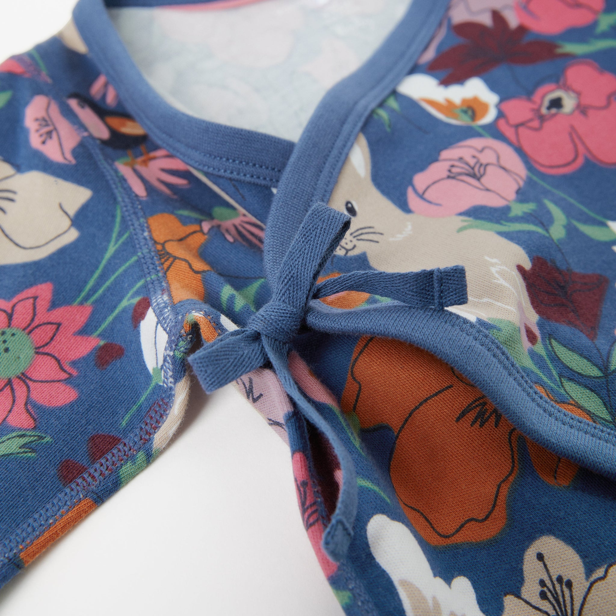 Nordic Blue Floral Baby Sleepsuit from the Polarn O. Pyret Kidswear collection. Clothes made using sustainably sourced materials.