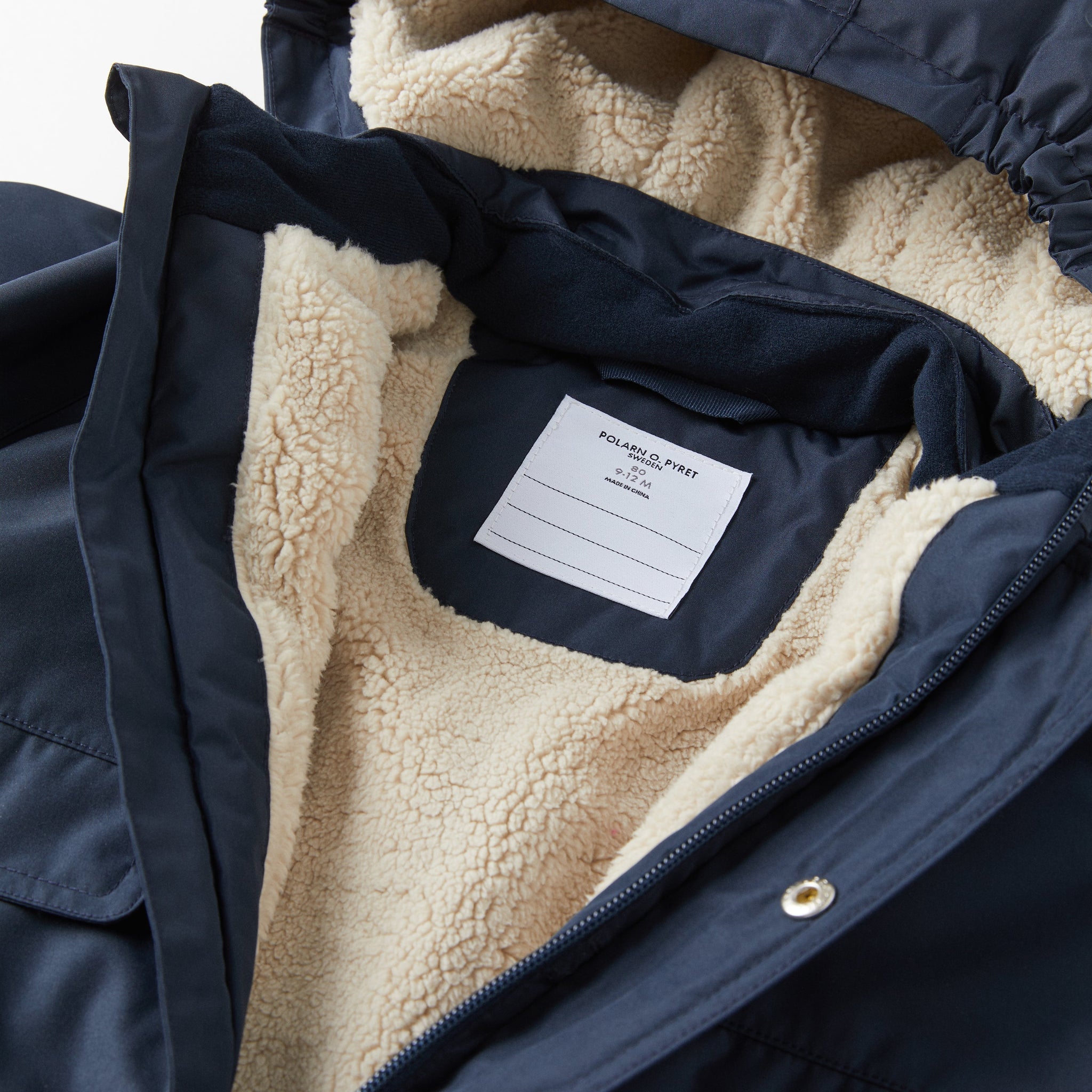 Padded Navy Baby Coat from the Polarn O. Pyret kidswear collection. Made using ethically sourced materials.