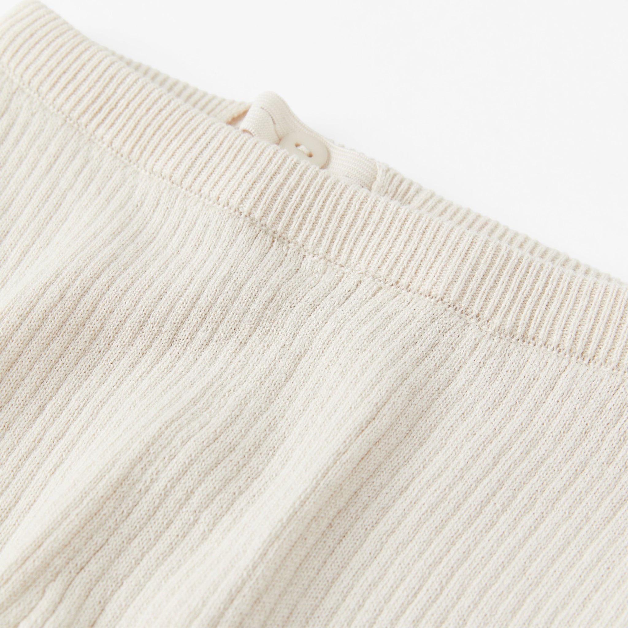 Ribbed White Knitted Baby Trousers from the Polarn O. Pyret babywear collection. Nordic baby clothes made from sustainable sources.