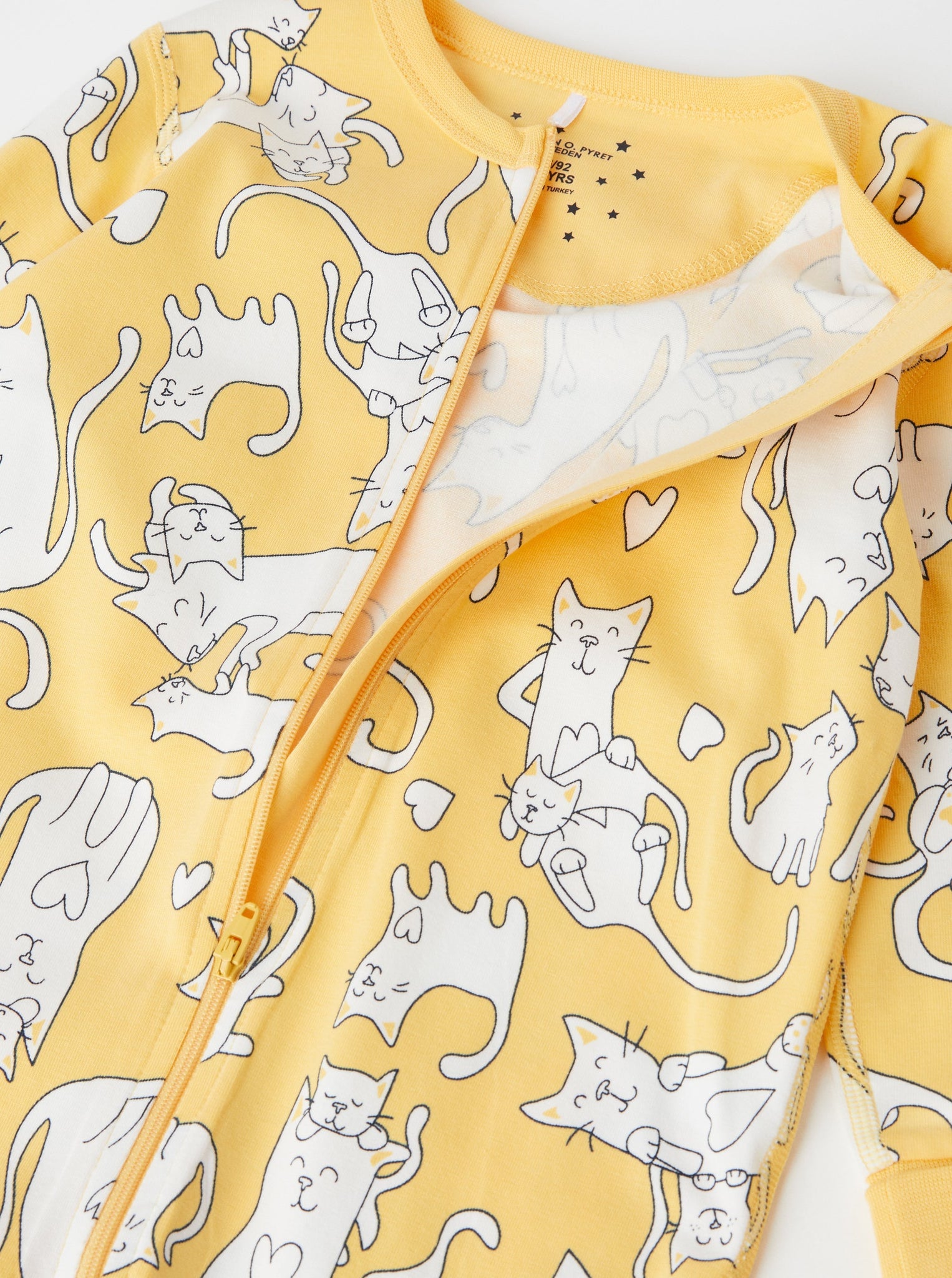 Cat Print Yellow Kids Sleepsuit from the Polarn O. Pyret babywear collection. Ethically produced kids clothing.