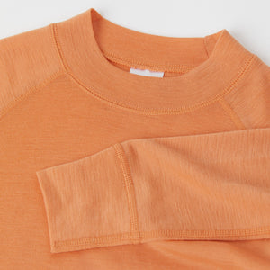 Orange Merino Wool Kids Thermal Top from the Polarn O. Pyret outerwear collection. Ethically produced kids outerwear.