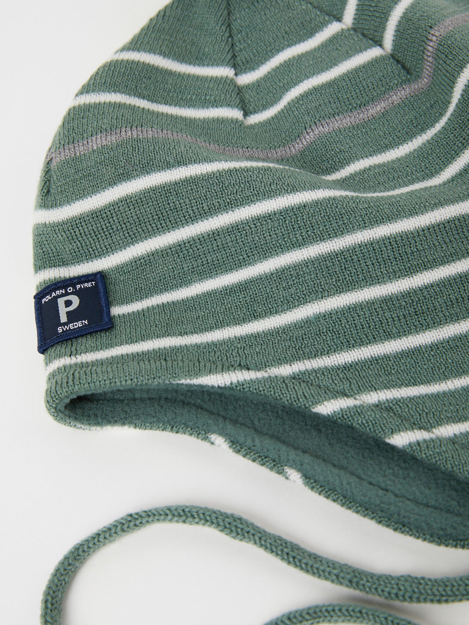 Merino Wool Green Kids Bobble Hat from the Polarn O. Pyret outerwear collection. The best ethical kids outerwear.