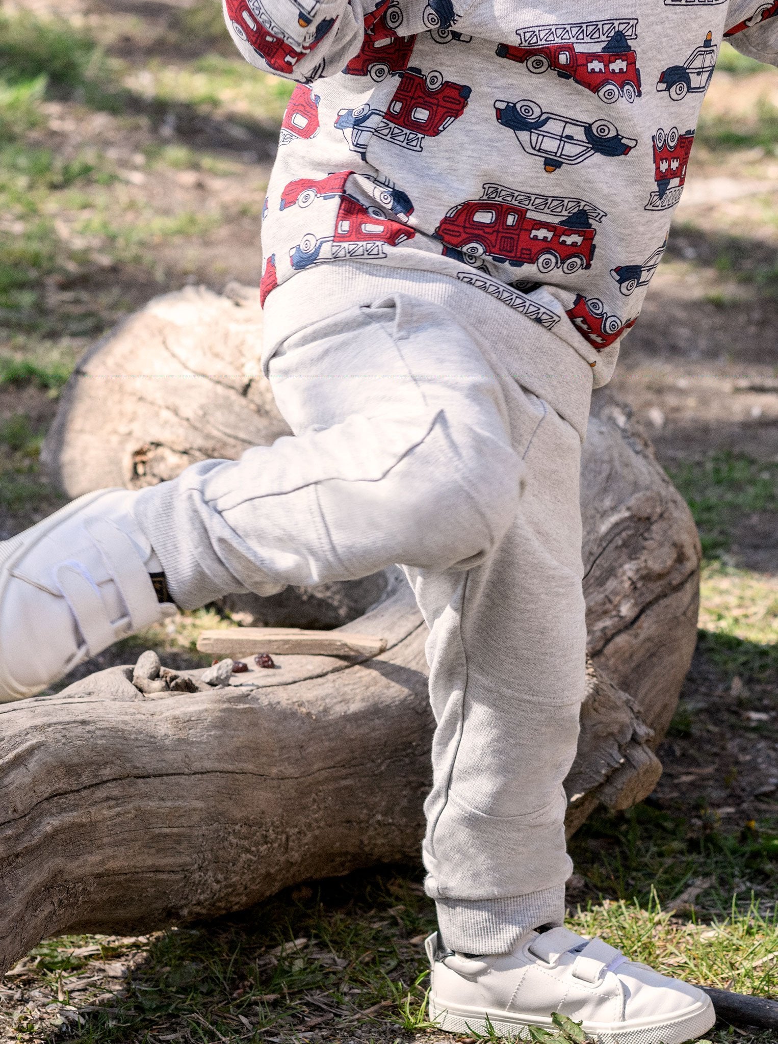 A kid wearing PO.P's grey joggers, made of soft, durable, and breathable organic cotton