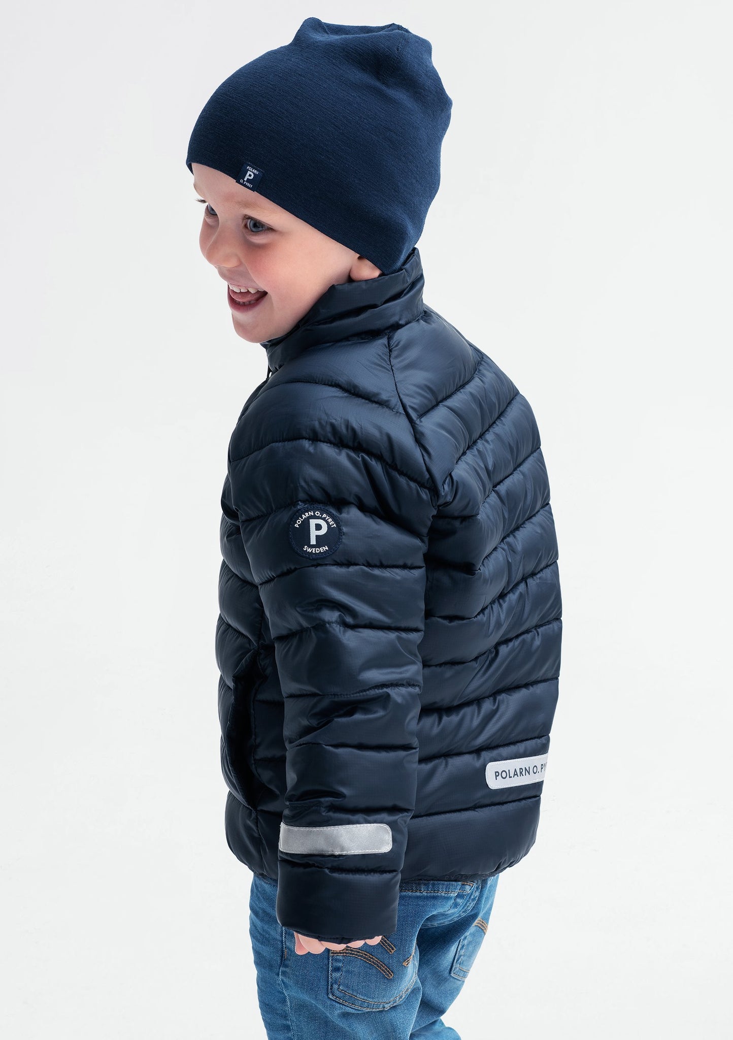 boy wearing navy water resistant kids puffer jacket, recycled materials, warm and comfortable, ethical long lasting polarn o. pyret