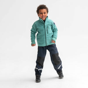 A little boy wearing a green, kids fleece jacket made with polyester paired with a navy, kids waterproof shell trousers.