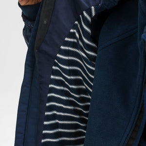 Close up shot of the striped inner lining of kids waterproof jacket in the colour navy, made of lightweight shell fabric.