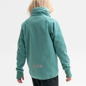 A back view of a young girl wearing a green, kids waterproof fleece jacket that comes with cuffs with thumbholes.