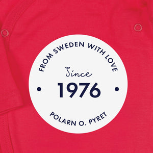 White round logo with 'From Sweden With Love, Since 1976" text, shown on a red organic cotton babygrow background.