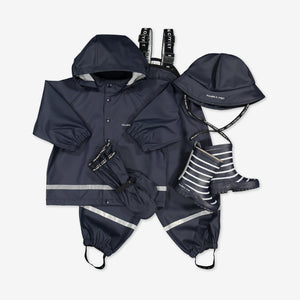 Kids outerwear set for rainy season, includes a navy, waterproof kids raincoat, rain trousers, rain hat and rain boots.