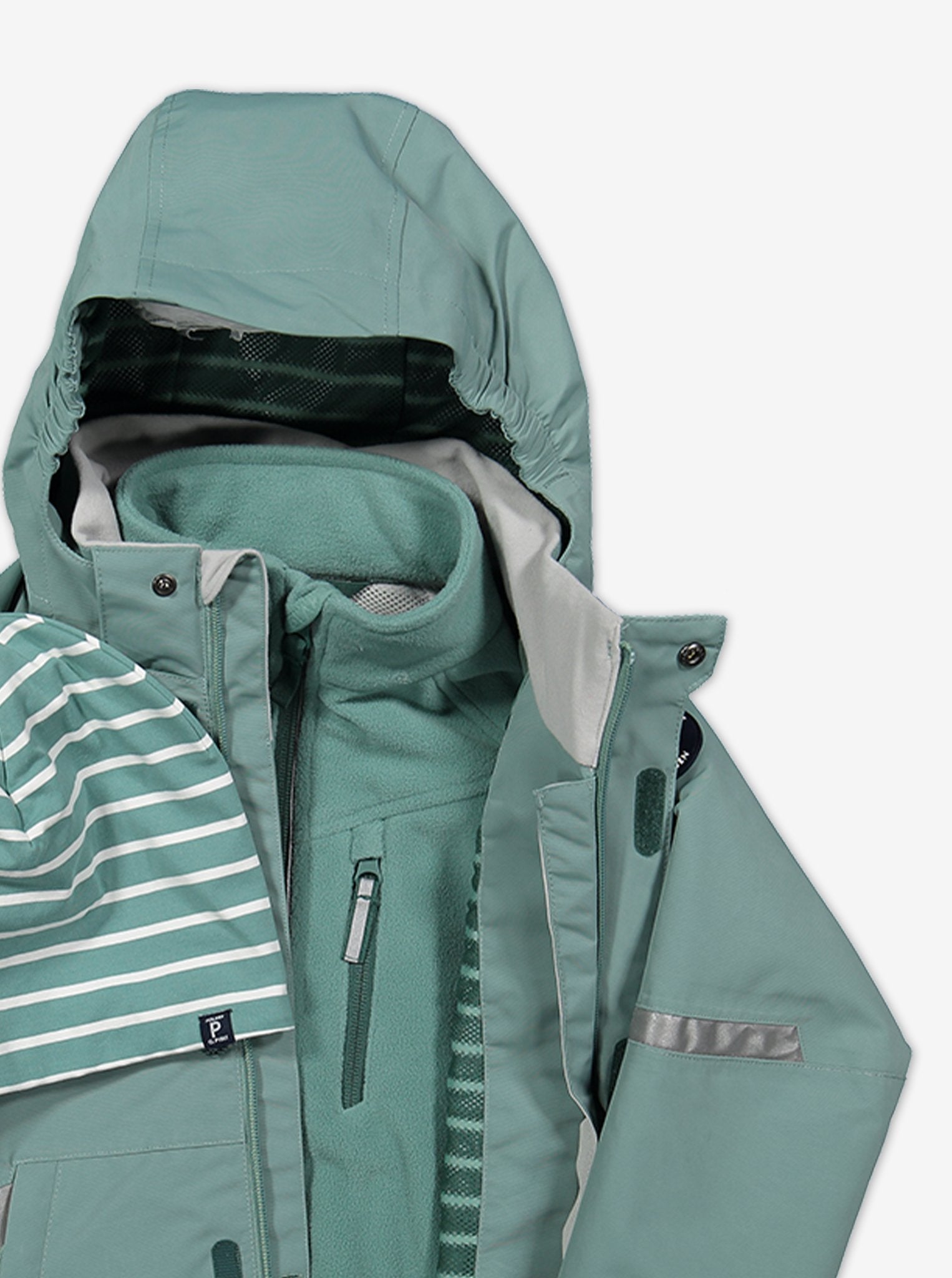 Close up view of a kids waterproof shell jacket, layered with kids waterproof fleece jacket in colour green.